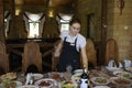 At a restaurant: waitress in uniform setting the table