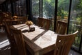 Restaurant wooden long table with green natural environment Royalty Free Stock Photo