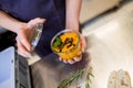 Restaurant worker holding souse in a bowl in kitchen