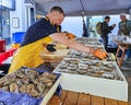 Restaurant workers open the shells of fresh oysters in the Berga Bazaar restaurant Royalty Free Stock Photo