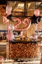 Restaurante room decorated for a birthday party with pink, black and transparent baloons of different sizes, large Royalty Free Stock Photo