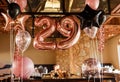 Restaurante room decorated for a birthday party with pink, black and transparent baloons of different sizes, large Royalty Free Stock Photo