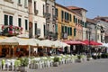 restaurants and bars, square with tables set in front of dining outlets, people sitting under restaurant umbrellas