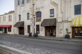 Restaurants, shops, and bars along River Street with colorful signs and balconies at sunset with a cobblestone road, people Royalty Free Stock Photo