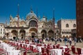 Restaurants and tourists at the famous Saint Mark Square of Venice in a beautiful sunny early spring Royalty Free Stock Photo