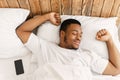 Rested African Guy Waking Stretching Hands Awakening In Cozy Bedroom Royalty Free Stock Photo