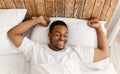 Rested African Man Waking Up Lying In Bed At Home