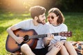 Restful couple of young people having relaxation outdoors enjoying pleasant moments and calm atmosphere. Romantic male with beard