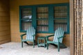 Restful green Adirondack chairs and side table on a sunny outdoor patio