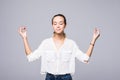 Restful peaceful woman feels relaxed, stands in lotus pose, tries to concentrate or to be focused, closes eyes, enjoys silence, tr Royalty Free Stock Photo