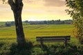 Resting bench in the countryside, sunset scenery