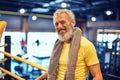 Resting after boxing training. Portrait of a positive handsome mature man in sportswear looking at camera and smiling Royalty Free Stock Photo