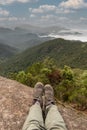 Resting feet on top of a mountain