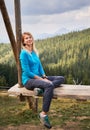 Resting on giant wooden swing outdoors at summer.