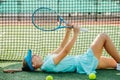 Resting girl fooling around during her break from her tennis practice. Royalty Free Stock Photo