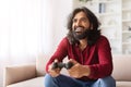 Happy young indian man playing video games at home Royalty Free Stock Photo