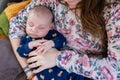 Resting infant cradled in Mother`s arms Royalty Free Stock Photo