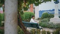 Resting macho holding flower sitting bench alone. Happy man waiting girlfriend Royalty Free Stock Photo