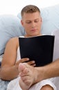 Resting male reading report Royalty Free Stock Photo