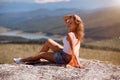 Resting moment. Time to relax. Enjoying life. Happy woman posing at edge of cliff. Breathtaking landscape on background Royalty Free Stock Photo