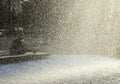 Resting people behind water drops curtain, Fountain in the Liberty Square Plac Wolnosci Poznan, Poland. Royalty Free Stock Photo