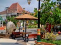 resting place benches and umbrellas made of black brown wood and iron, bright blue sky in the garden of the city of Madiun