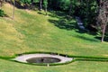 Resting place with wooden benches at a round fountain.