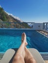 Resting at the pool sunbed vith a view at the Santorini Island, Greek, Cyclades