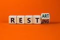 Resting and restart symbol. Turned a wooden cube and changed the word resting to restart. Beautiful orange table, orange