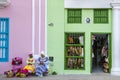 Street entertainers - flower girls - women in traditional costumes sitting in front of colorful souvenir shops, Havana, Cuba