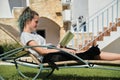 Resting teenager girl reading book with black domestic cat Royalty Free Stock Photo