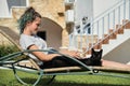 Resting teenager girl reading book with black domestic cat Royalty Free Stock Photo