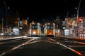 Resting trams locate on rails in city street at night time Royalty Free Stock Photo