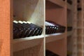 Resting wine bottles stacked on wooden racks