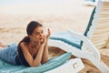 woman smiling lying sunbed sea ocean sand travel lifestyle resort beach