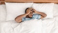 Restless african american man waking up with headache Royalty Free Stock Photo