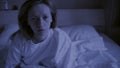 Restless dreams of sleeping woman interrupted by waking up for nightmares