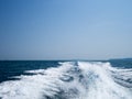 Restless foamy blue sea wake water on the sea water surface with clear blue sky while travel by speed boat in the ocean Royalty Free Stock Photo