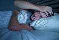 Restless worried young attractive man awake at night lying on bed sleepless with eyes wide opened suffering insomnia sleeping diso Royalty Free Stock Photo