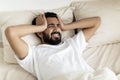 Restless Young Indian Man Waking Up In The Morning With Headache Royalty Free Stock Photo