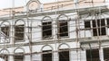 Restoration facade of tall house, scaffolding construction