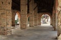 Restored brick colonnade to house the city market, italian middleage style