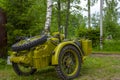 Restored bright green retro motorcycle with sidecar