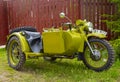 Restored bright green retro motorcycle with sidecar