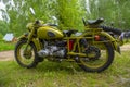 Restored bright green retro motorcycle with sidecar