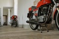 Restored MV Agusta motorcycles in an old hallway with a flagstone floor at Chateau de Savigny near Beaune in Burgundy, France