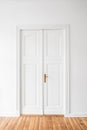 Restored old door in renovated flat - white door, white wall Royalty Free Stock Photo