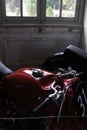 Restored Parilla motorcycle in shadow with faded painted window at Chateau de Savigny near Beaune in Burgundy, France Royalty Free Stock Photo