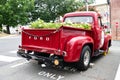 Restored red pickup truck from the 50s, Ford F100 in the parking lot. Back view Royalty Free Stock Photo