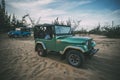 Restored retro car during the American Vietnam war on the sand in the desert of Vietnam. Royalty Free Stock Photo